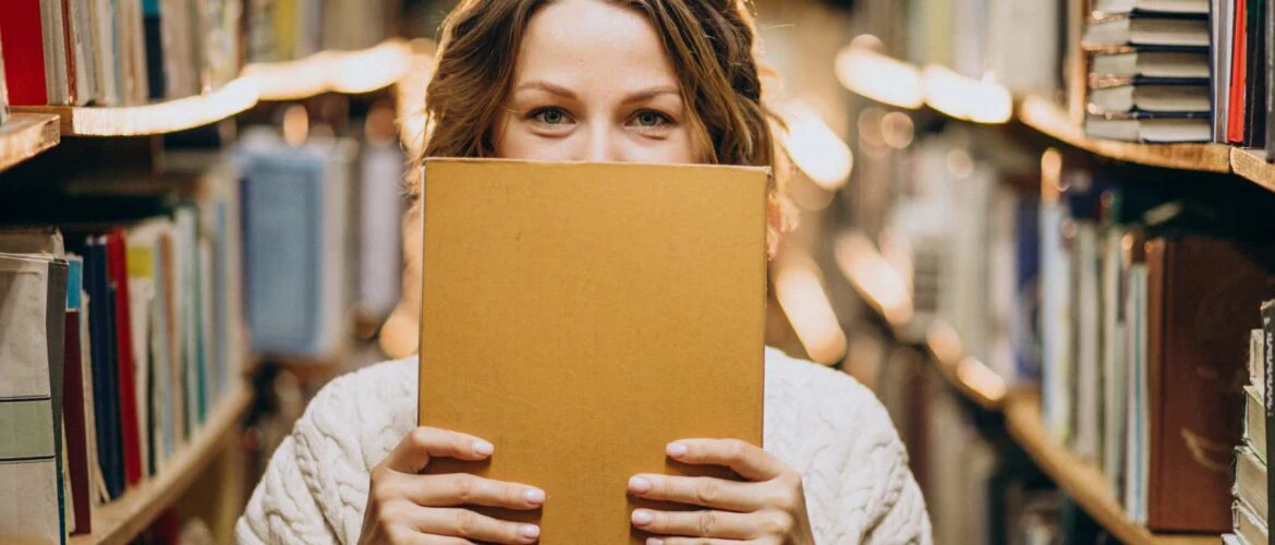 GrowthPro Learning: Student holding a study guide for the exam